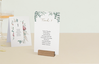 eine aufgestellte Gruppentischkarte und eine andere Gruppentischkarte in einem Holzfuß aufgestellt